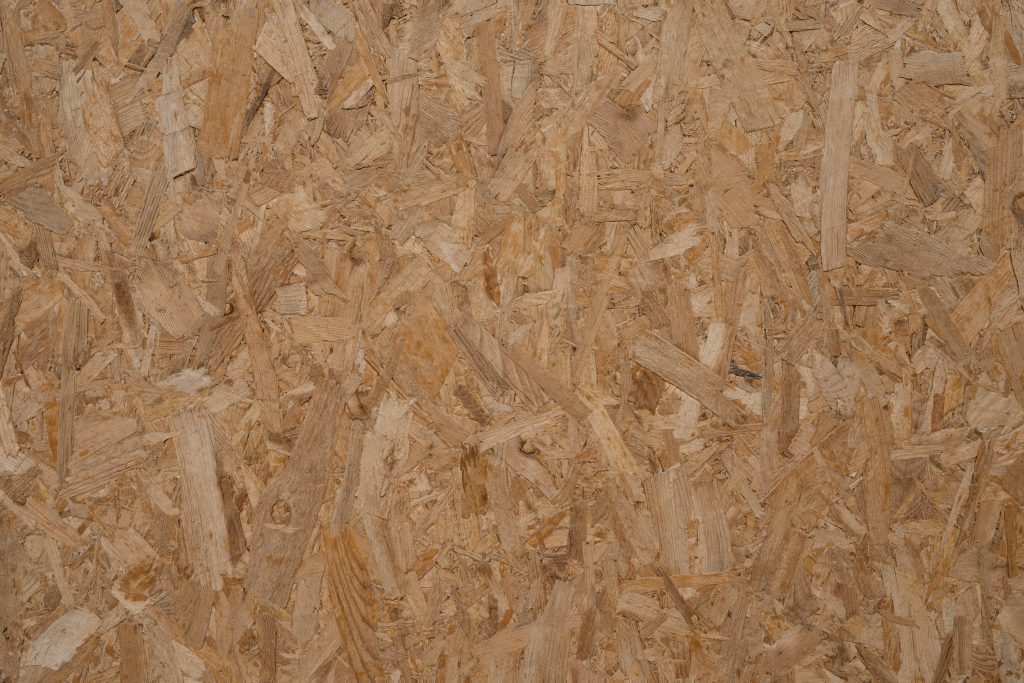 Detailed texture of a natural wooden OSB panel, perfect for backgrounds and design elements.