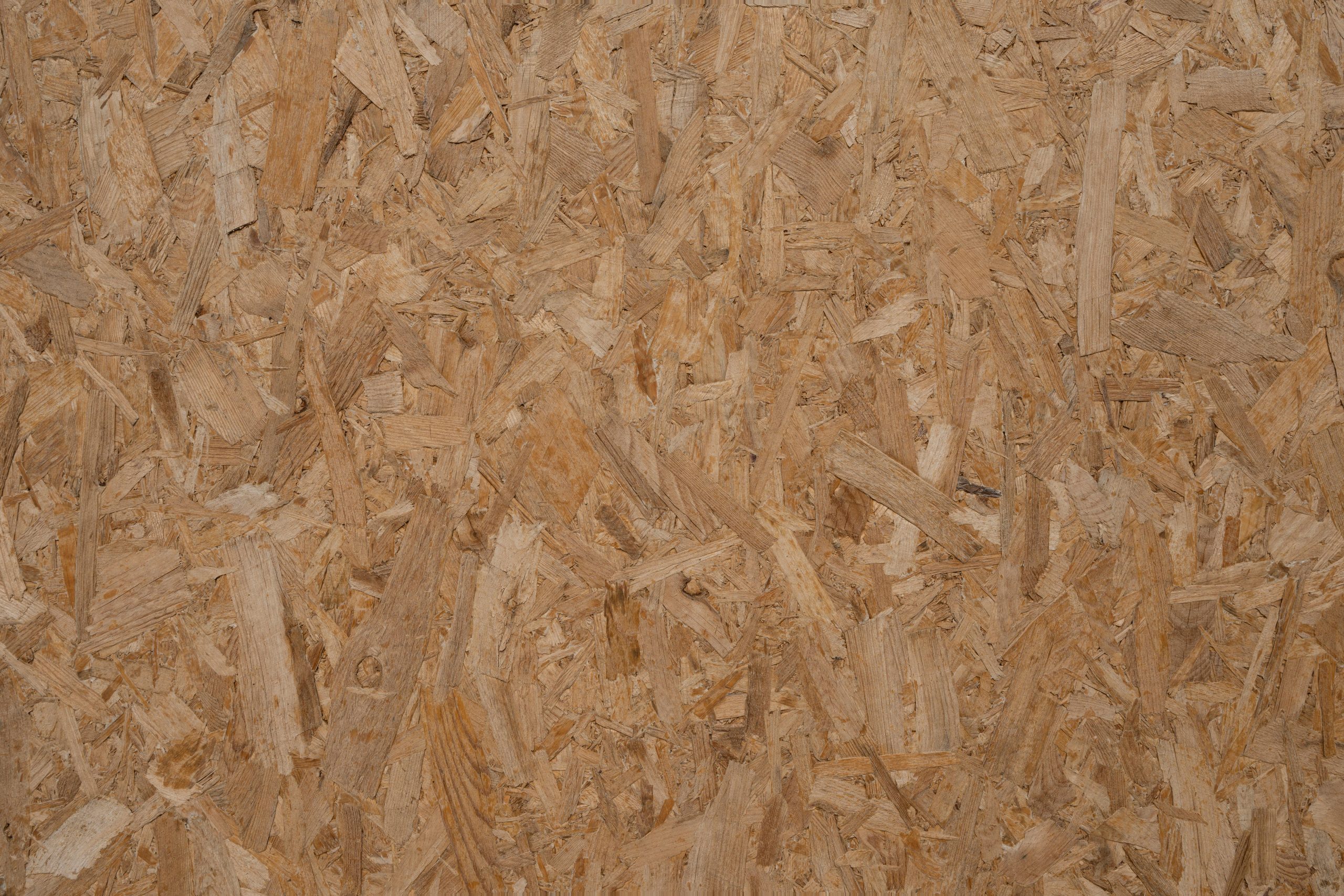 Detailed texture of a natural wooden OSB panel, perfect for backgrounds and design elements.